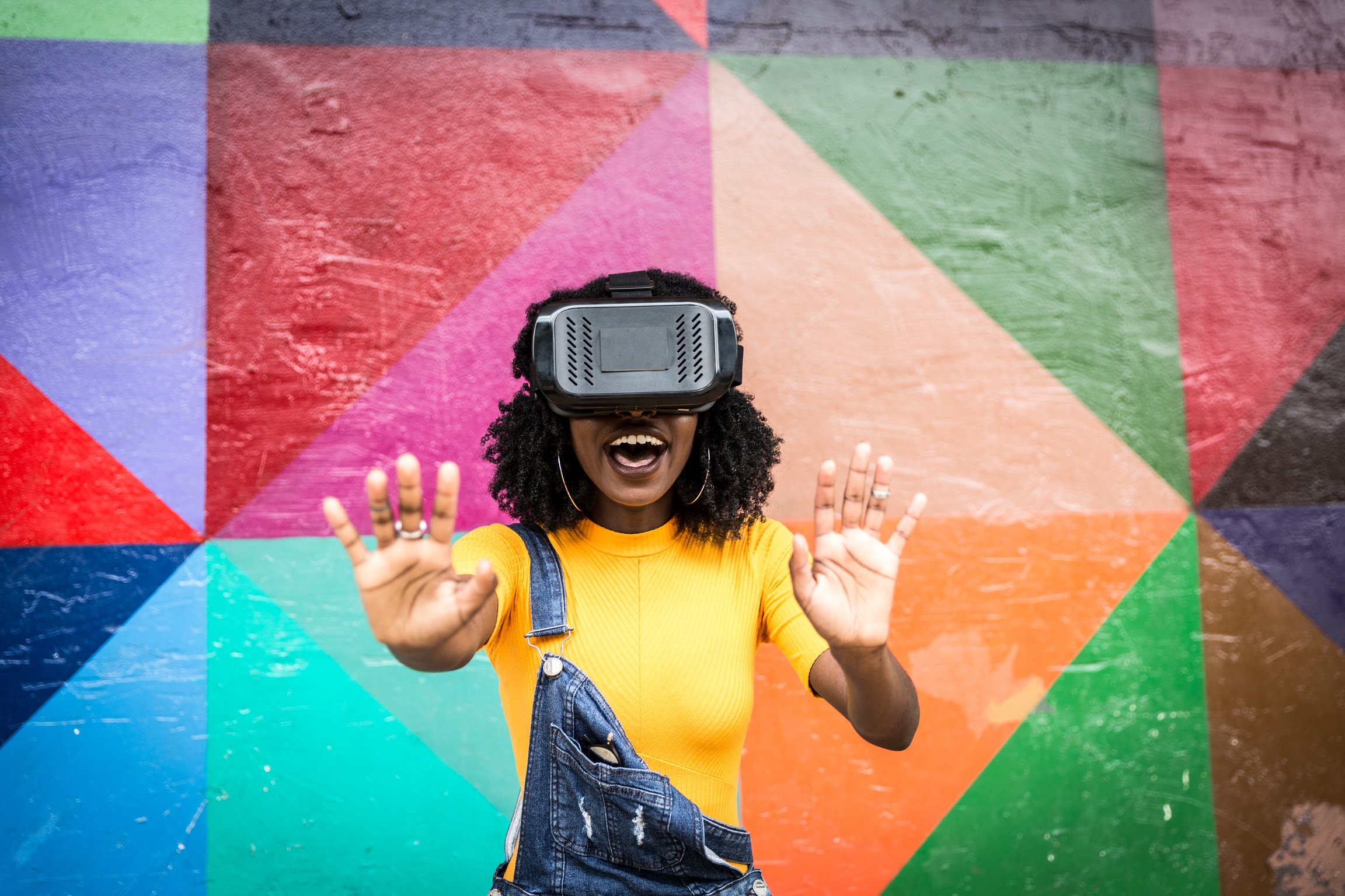 African decent woman wearing virtual reality goggles